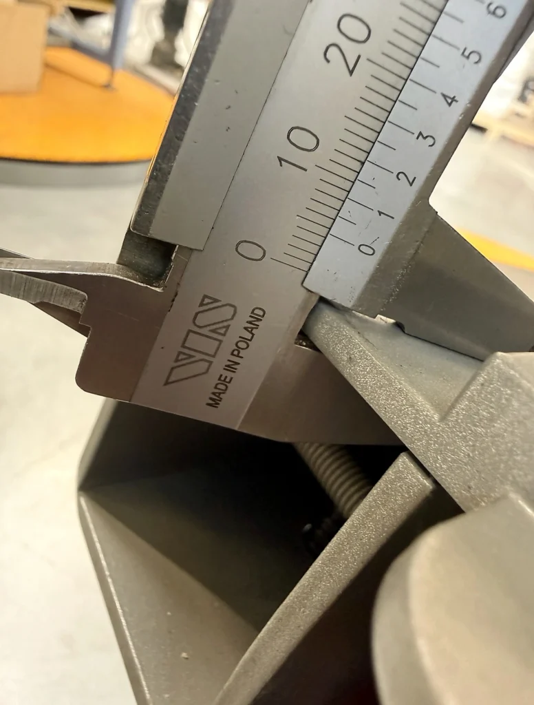 Calliper measuring the steel mast wall thickness on a POLPACK ZEUS Wrapper